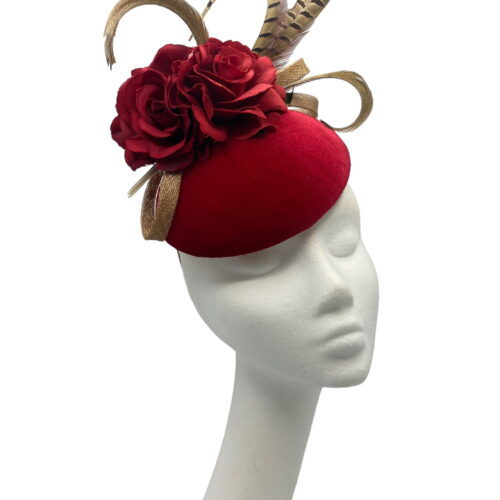 Red velvet based headpiece with red flower and finished with brown feathered detail.